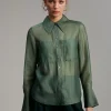Blusa bolsillos transparencia